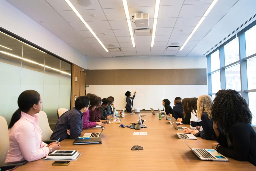 A business meeting in a modern conference room with large windows