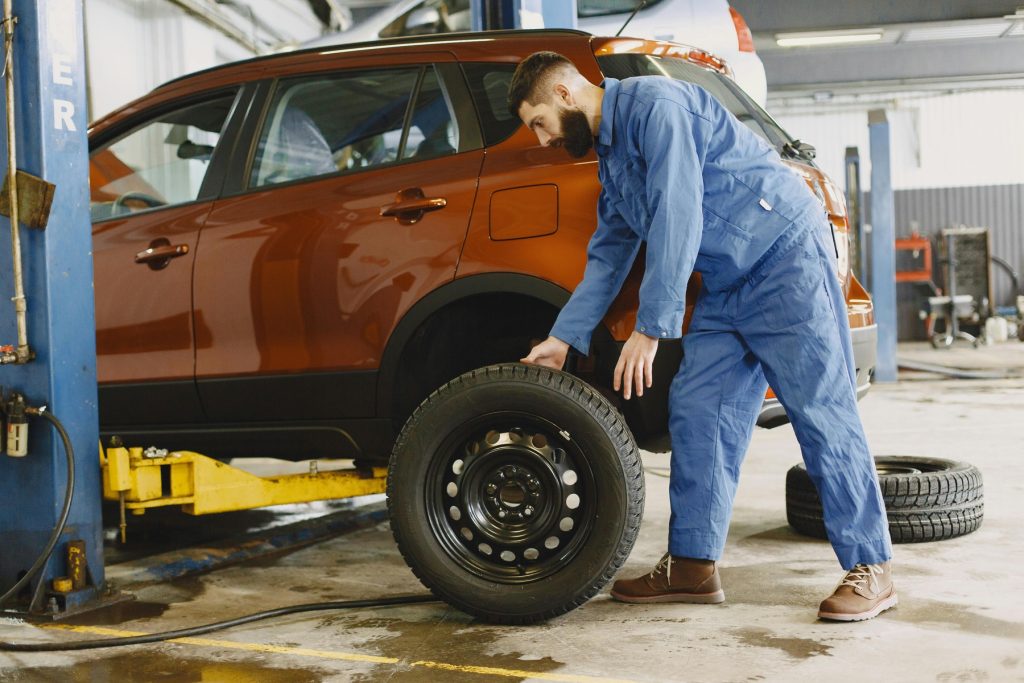 A technician working on the wheels of a car