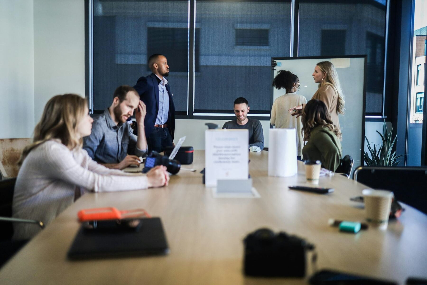 Several individuals gathered in a meeting room